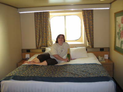 Large bed in stateroom with Champagne model